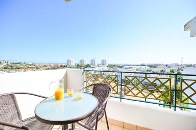 a table and chairs on a balcony with a view at L14 by MTPhomes in Vale de Pedras