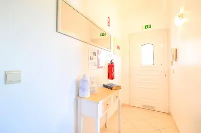 a bathroom with a sink and a white door at L14 by MTPhomes in Vale de Pedras