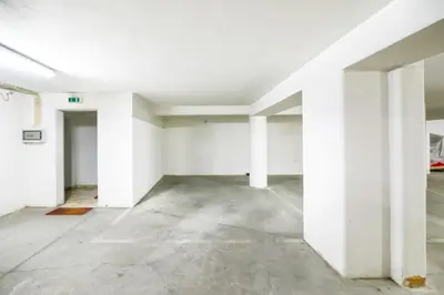 an empty room with white walls and white pillars at L14 by MTPhomes in Vale de Pedras