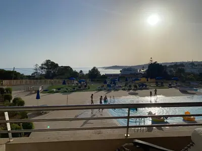 a swimming pool with people in a park at Beachfront flat, private parking, pools, sea at less than 200 m in Albufeira