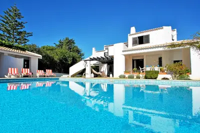 a villa with a swimming pool in front of a house at Villa Mauritius by Algarve Vacation in Albufeira