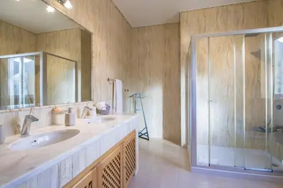 a bathroom with two sinks and a shower at Villa Mar in Almancil