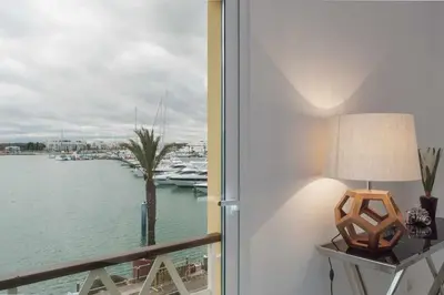 a room with a window with a view of a marina at Boat View - Marina Plaza - By VilamouraSun in Vilamoura
