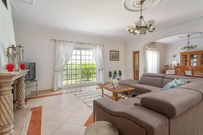 a living room with two couches and a table at Fonte Santa Villa in Quarteira