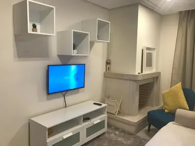 a living room with a tv and a fireplace at Apartment Calcada in Albufeira