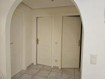 two white doors in a hallway with a tile floor at Apartment Calcada in Albufeira