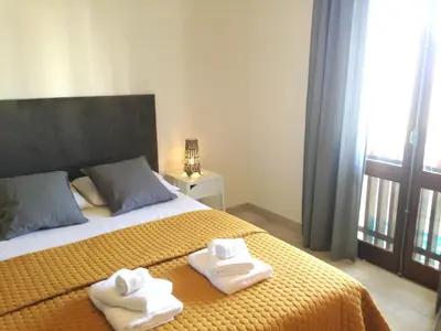 a bedroom with two towels on a bed with a window at Casa Marina in Vilamoura