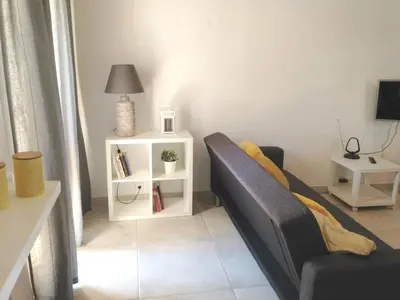 a living room with a couch and a table at Casa Marina in Vilamoura