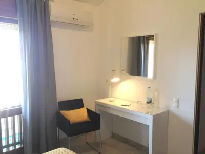 a room with a desk and a chair and a mirror at Casa Marina in Vilamoura