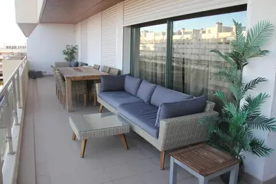 a blue couch on a balcony with a table at Marina Vilamoura Apartment in Vilamoura