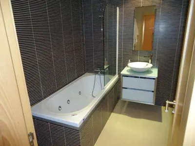 a bathroom with a bath tub and a sink at Marina Vilamoura Apartment in Vilamoura