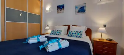 a bedroom with two bags on a bed at Parque Atlântico in Quarteira