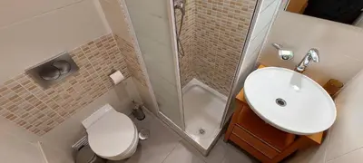 a bathroom with a sink and a toilet and a shower at Parque Atlântico in Quarteira