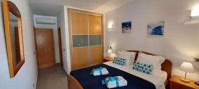 a bedroom with a bed with two towels on it at Parque Atlântico in Quarteira