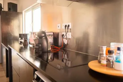 a kitchen with a counter with a appliance on it at Wax Suite Life is a beach in Faro