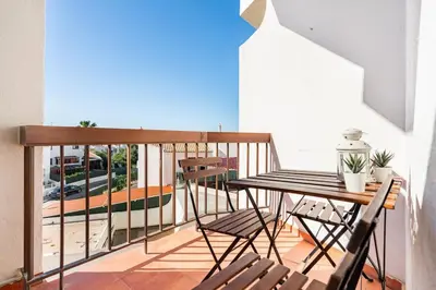 a balcony with a table and chairs on a balcony at Aqua Magna Apartment in Albufeira