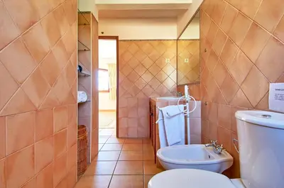 a bathroom with a toilet and a sink at Charming House Vilamoura in Vilamoura