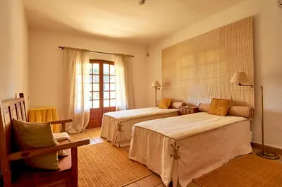 a bedroom with two beds and a window at Charming House Vilamoura in Vilamoura