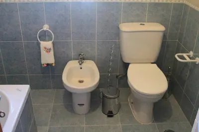 a small bathroom with a toilet and a sink at MSHomes Corcovada in Albufeira