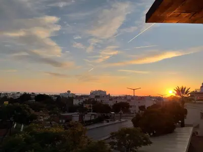 a view of a city at sunset from a building at MSHomes Corcovada in Albufeira