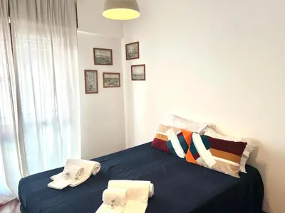 a bedroom with a blue bed with towels on it at Casa Marum in Faro