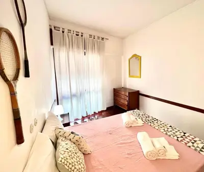 a bedroom with a bed with two towels on it at Casa Marum in Faro