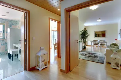 a living room with a door open to a dining room at Marina Coast Residence in Albufeira