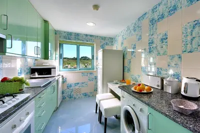 a kitchen with blue and white tiles on the walls at Marina Coast Residence in Albufeira