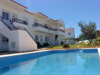 a swimming pool in front of a house at Apartment with 1 Bedroom D in Albufeira