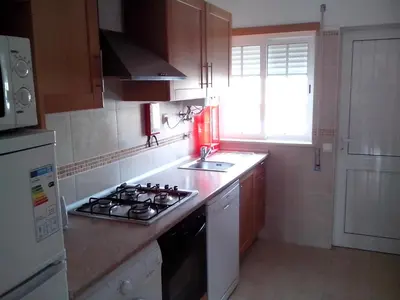 a small kitchen with a stove and a sink at Apartment with 1 Bedroom L in Albufeira