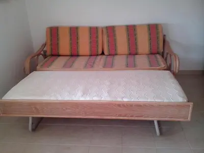 a wooden bench sitting in the corner of a room at Apartment with 1 Bedroom L in Albufeira