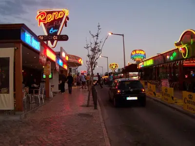 a city street with many neon signs and a car at Apartment with 2 Bedrooms B in Albufeira