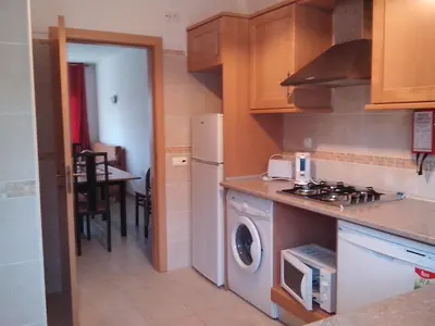 a kitchen with a stove and a washer and dryer at Apartment with 2 Bedrooms B in Albufeira