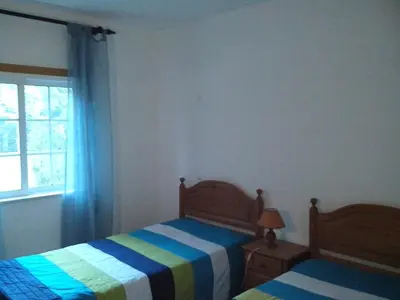 a bedroom with two beds and a window at Apartment with 2 Bedrooms B in Albufeira
