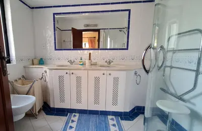 a bathroom with a sink and a mirror at Dunas Douradas Beach Villa in Benfarras