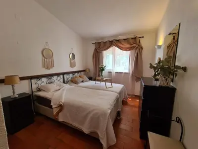 a bedroom with two beds and a window at Aldeia do Golf - Vila I8 in Vilamoura