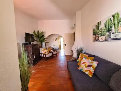 a living room with a couch and a table at Aldeia do Golf - Vila I8 in Vilamoura
