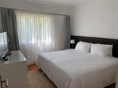 a bedroom with a white bed and a window at Quinta do lago & golf in Quinta do Lago