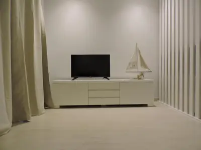 a tv sitting on top of a dresser in a room at Sao Rafael - Apartamento Studio in Albufeira