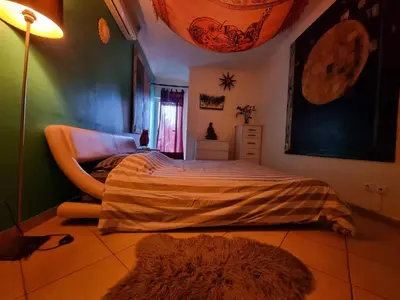 a bedroom with a bed and a lamp and a rug at T1 Falesia in Albufeira