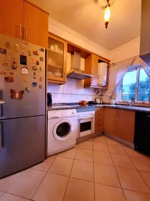 a kitchen with a stainless steel refrigerator and a dishwasher at T1 Falesia in Albufeira