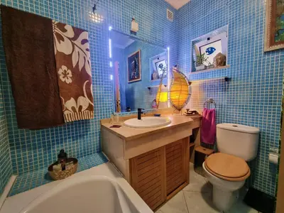 a bathroom with a tub and a sink and a toilet at T1 Falesia in Albufeira