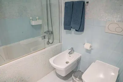 a bathroom with a sink and a toilet and a shower at Garden Hill Apartment in Albufeira