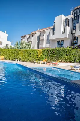 a swimming pool in front of a building at Garden Hill Apartment in Albufeira