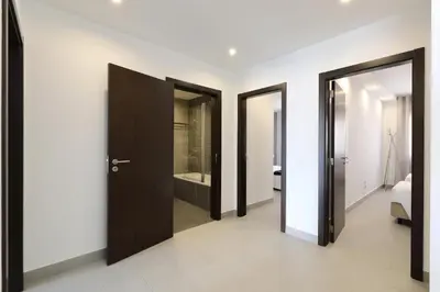 a hallway with four doors in a room at Original 3 Bedroom Downtown in Albufeira