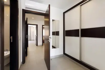 a bathroom with sliding glass doors and a hallway at Original 3 Bedroom Downtown in Albufeira
