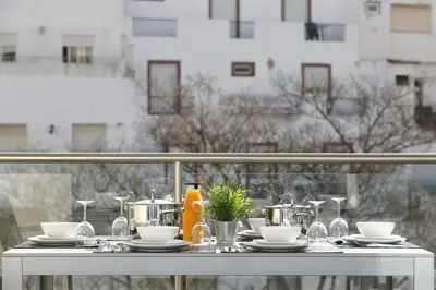 a table with pots and pans on a balcony at Original 3 Bedroom Downtown in Albufeira