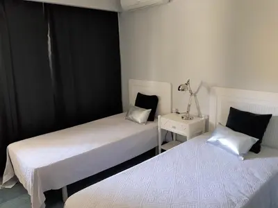 two beds sitting next to each other in a bedroom at By the Beach in Almancil