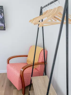 a chair and a table in a room at Dear Faro - Guest House in Faro