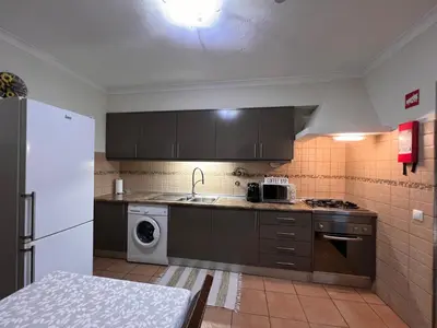 a kitchen with a sink and a washing machine at Quinta dos Viegas in Faro